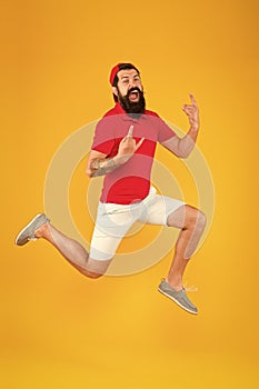 Full of strength and energy. Hipster dancing jumping. Feeling free. Running man yellow background. feel himself