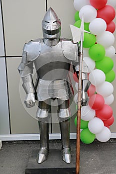 Full suit of knight armour and weapon on the street on balloon background.