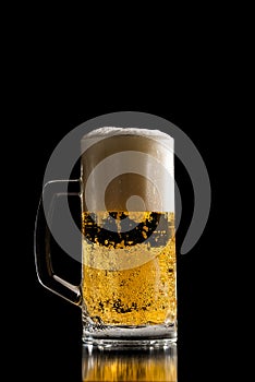 Full tankard of chilled beer with a frothy head