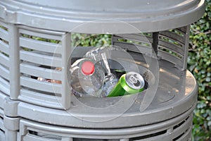 Full trashcan with cans and plastic bottles