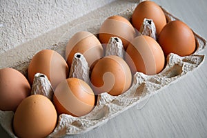 Full tray with chicken eggs. Eggs cardboard container. Close-up. Selective focus