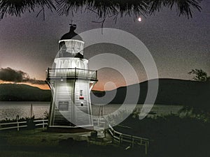 Full view of Akaroa Head lighthouse, Canterbury region of the South Island of New Zealand at night