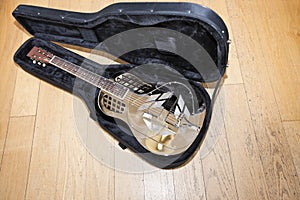 Full view of resonator guitar in carry case