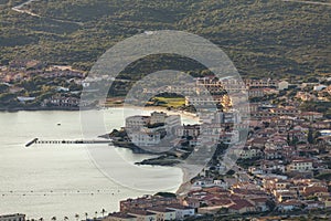 Full view of the main beaches in Golfo Aranci, Olbia, with buildings and town view photo