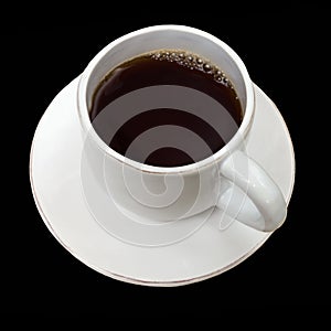 Full white fictile cup of tea and dish isolated on black background photo