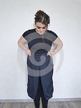 Full woman tries on too small pants lose diet measurement