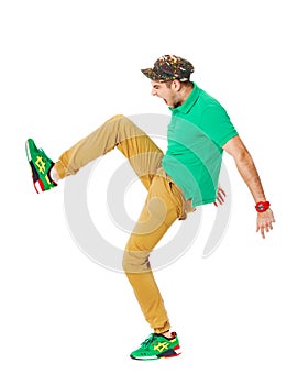 Fullbody portrait of young male kicking in studio isolated on white.