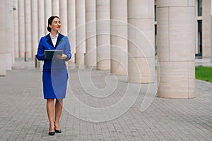 Fulllength view of a girl in a stylish suit near the business center. Admission to the position during the coronavirus photo