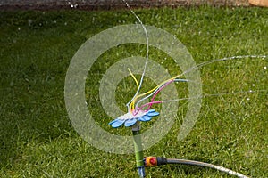 Fully automatic garden grass sprinkler system. Sprinkler wires Splashing water everywhere