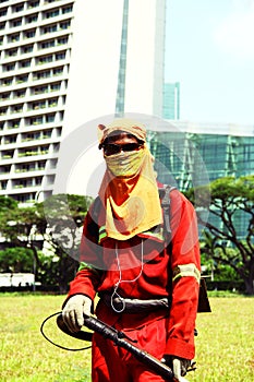 Fully covered mowing worker in singapore