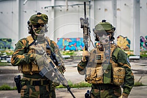 Fully equipped special forces soldiers posing with weapons