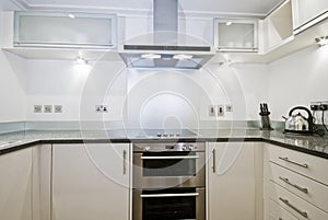 Fully fitted contemporary kitchen in white photo