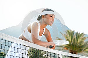 Fully focused on becoming a winner. a sporty young woman playing tennis on a court.