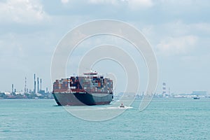 Fully loaded, cargo container ship departing from port of Singapore.