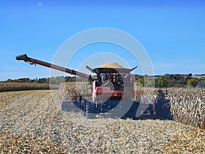 Fully loaded combine harvester waiting for grain cart to unload