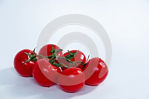 Fully ripened tomatos on a white bcakground photo