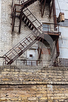 Fully rusty iron staircase in an abandoned old Soviet industrial