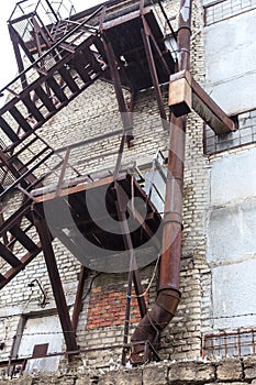 Fully rusty iron staircase in an abandoned old Soviet industrial