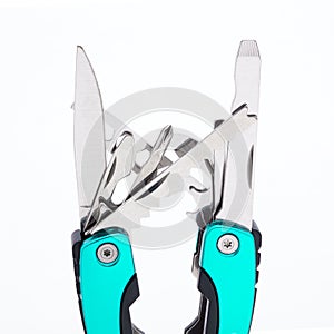 Fully unfolded multitool isolated on white background