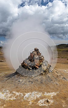 Fumarole engaging vapor and smoke in Hverarond hydrothermal site in Northern Island photo