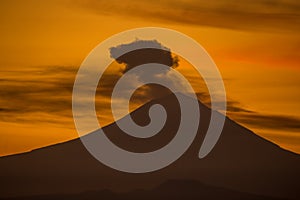 Fumarole on the volcano with red colors at sunrise