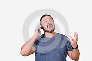 A fuming mad man arguing with a customer service representative over the phone. A livid guy making threats. Isolated on a white