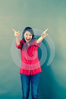 Fun 30s woman shouting with extrovert hand gesture