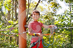 Fun at adventure rope park little boy portrait