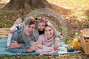 Fun is all in the family. a happy young family enjoying a picnic in the park.