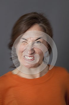 Fun angry expression for winking middle aged woman, blur effects