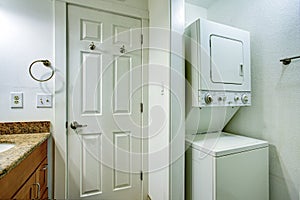 Fun bathroom with bathroom vanity and stacked washer and dryer photo