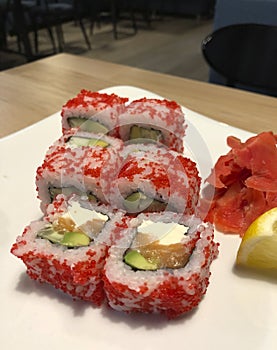 Fun beautiful sushi with red caviar on a plate with lemon