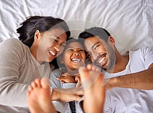 Fun, bed and happy family playing, wake up and happy from above, tickle and laughing in their home. Bedroom, games and