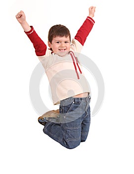 Fun boy in jeans high jump.