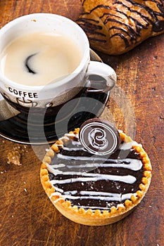 Fun cakes on wood background with coffee