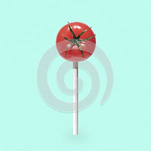 Fun candy tomato on a stick. Minimal pop art concept of healthy eating.