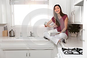 Fun cute friendly asian american woman relaxed at home with a book, cute, funny, warm, likable