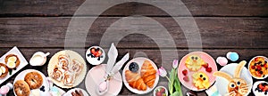 Fun Easter breakfast or brunch bottom border. Top view on a dark wood banner background.