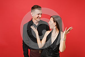 Fun expression young couple in black clothes shirt dress celebrating birthday holiday party on bright red