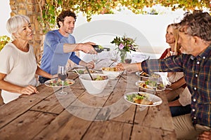 Fun family celebrations. A group of people preparing to enjoy lunch together.