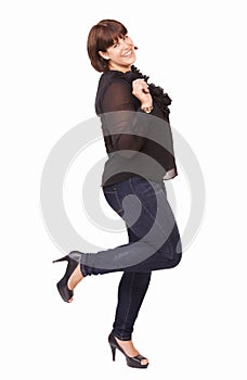 Fun and flirty. Portrait of a playful young brunette woman lifting on foot on a white background.