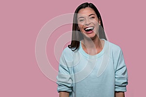 Fun friendly female brunette portrait, laughing and smiling with perfect white teeth smile, advertising copy space