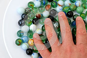 Fun game for kids with colored glass marbles, glass balls