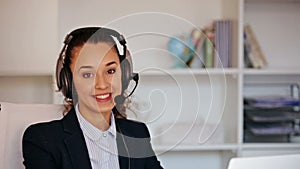 A fun girl with a headset answering the phone in the office