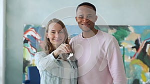 Fun happy mixed race couple holds the key to their new home