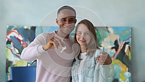 Fun happy mixed race couple holds the key to their new home