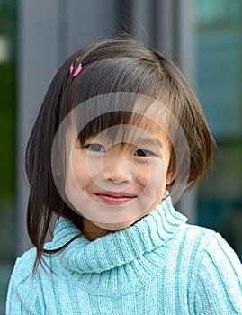 Fun happy pretty little girl grinning at camera