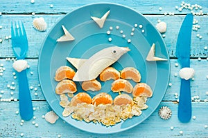 Fun and healthy food - fruit dolphin, summer season and sea vacation edible concept