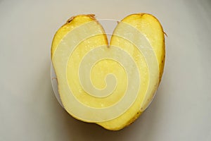 Fun heart shape potato on bright background