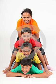 Fun human totem pole by four young school friends